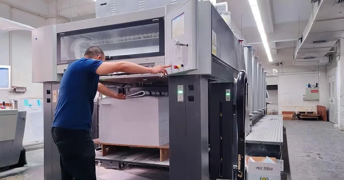 An offset printing press running a book job